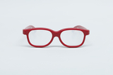 Das Bild zeigt eine rote Brille mit klaren Gläsern, die zentral auf einem weißen Hintergrund platziert ist. Sie ist für experimentelle Bildungszwecke konzipiert und könnte in Schulen oder für wissenschaftliche Anwendungen verwendet werden.