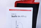 Das Bild zeigt ein Schüler-Set mit dem Titel "Stoffe im Alltag" aus dem Cornelsen Experimenta. Es ist Teil eines Experimentierbedarfs für das deutsche Bildungswesen und thematisiert die praktischen Anwendungen von Stoffen im täglichen Leben.