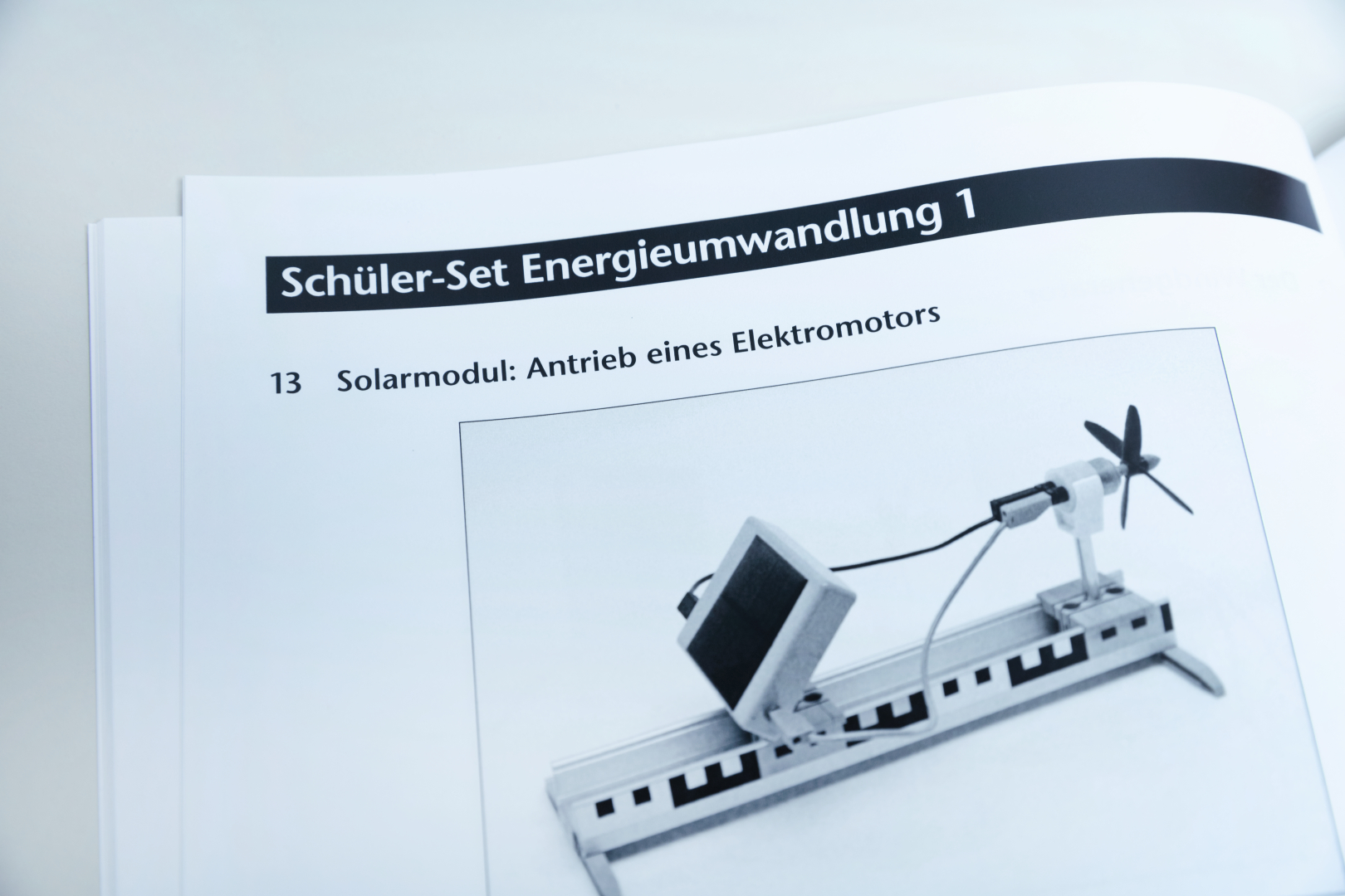 Das Bild zeigt eine Anleitung für ein Schüler-Set zur Energieumwandlung, das ein Solarmodul zur Ansteuerung eines Elektromotors beschreibt. Es ist Teil eines didaktischen Materials zur Vermittlung von Konzepten der erneuerbaren Energien.