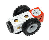 Ein modularer Roboter mit großen Gummireifen und bunten, quadratischen Bausteinen dient als Experimentiergerät für Bildungseinrichtungen. Die verschiedenen Steuerungselemente auf den Bausteinen ermöglichen interaktive Lernmöglichkeiten in den Bereichen Technik und Programmierung.
