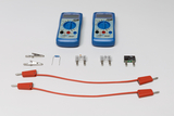 Zwei blaue Digitalmultimeter von PeakTech liegen über verschiedenen elektronischen Bauteilen wie Widerständen, Sicherungen und Klemmen. Im Vordergrund befinden sich zwei rote Verbindungskabel mit Steckern.